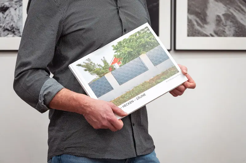 Diploma Exhibition of Prague Photo School: Artist Holding Exhibition Catalog