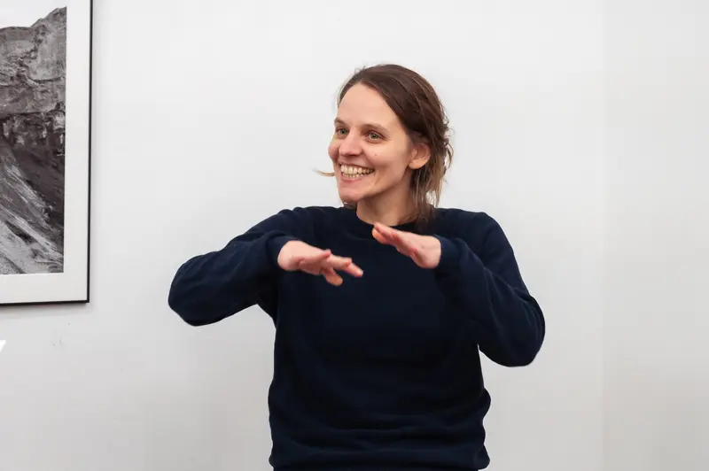 Hannah Mayr Smiling and Gesturing During Prager Fotoschule Diploma Exhibition