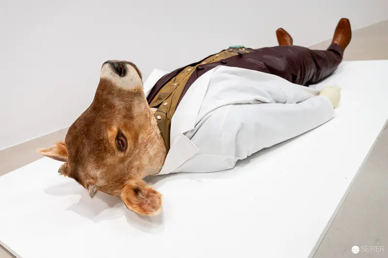 Surreal Taxidermy Art Piece Depicting Reclining Animal Figure in White Costume