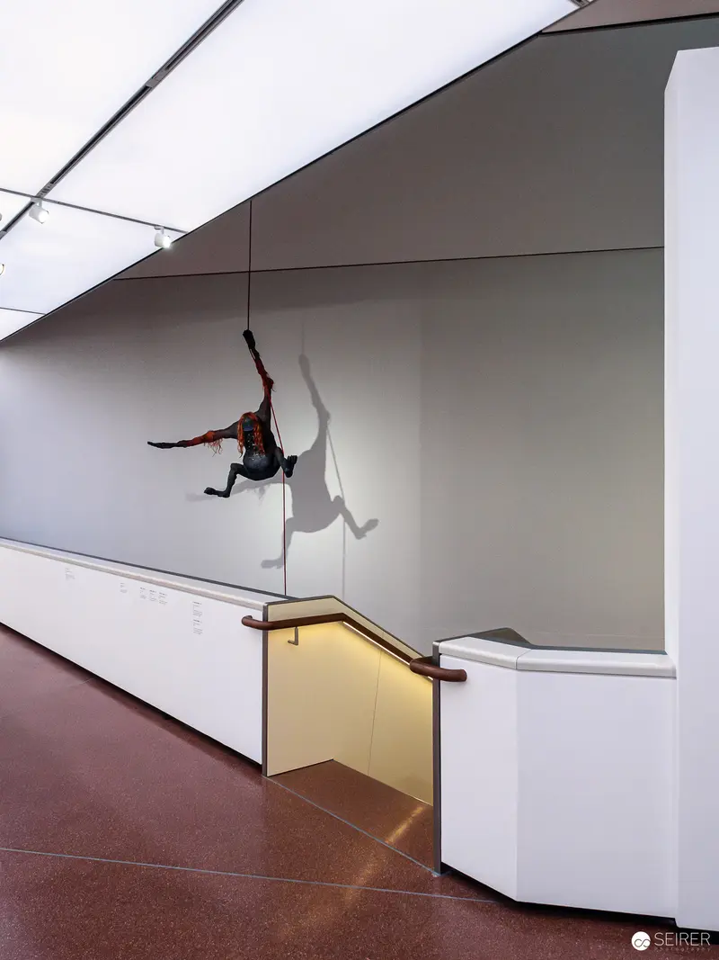 Dramatic Pole Dancer Suspended in Minimalist White Gallery Space