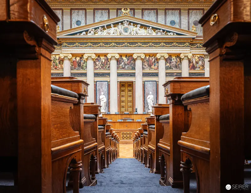 Austrian Parliament Interior: Wooden Benches and Neoclassical Architecture in Historic Legislative Chamber