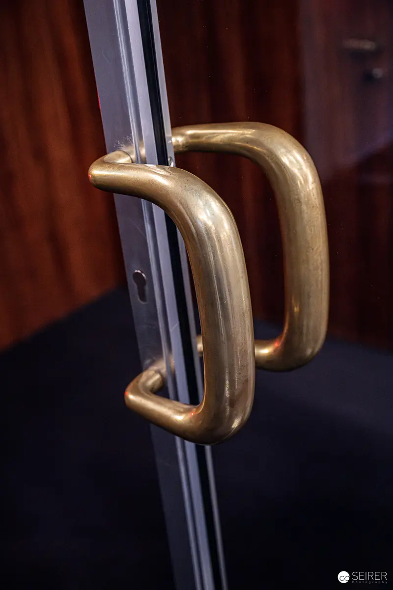 Brass Door Handles on Glass and Metal Architecture Detail