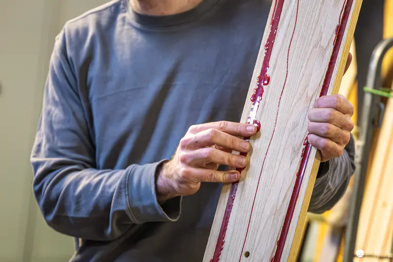 Craftsman Carefully Handling Ski Wood at Ünique Skis Workshop in Vienna