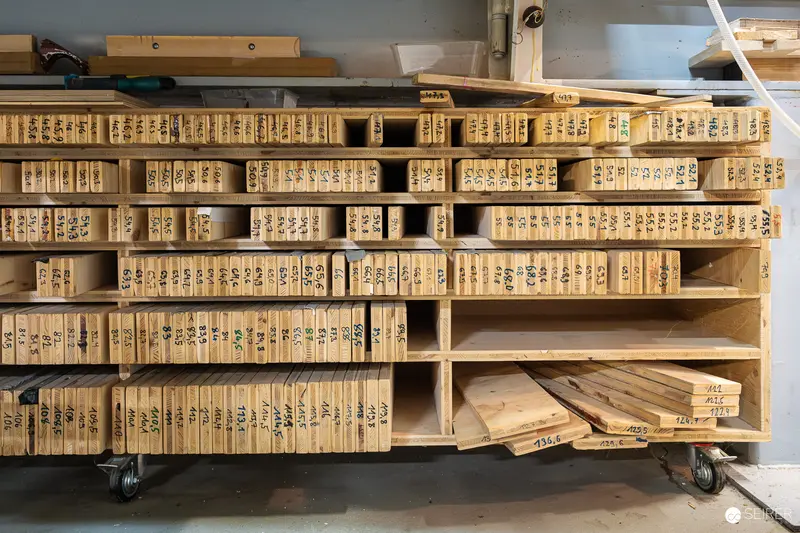 Organized Wooden Ski Blank Inventory on Wheeled Workshop Shelving