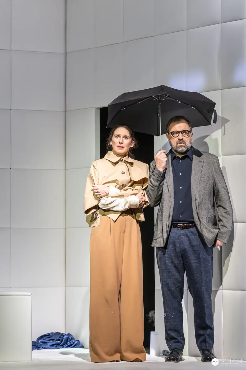 James Brown and Partner Under Umbrella in Yasmina Reza's Theater Production