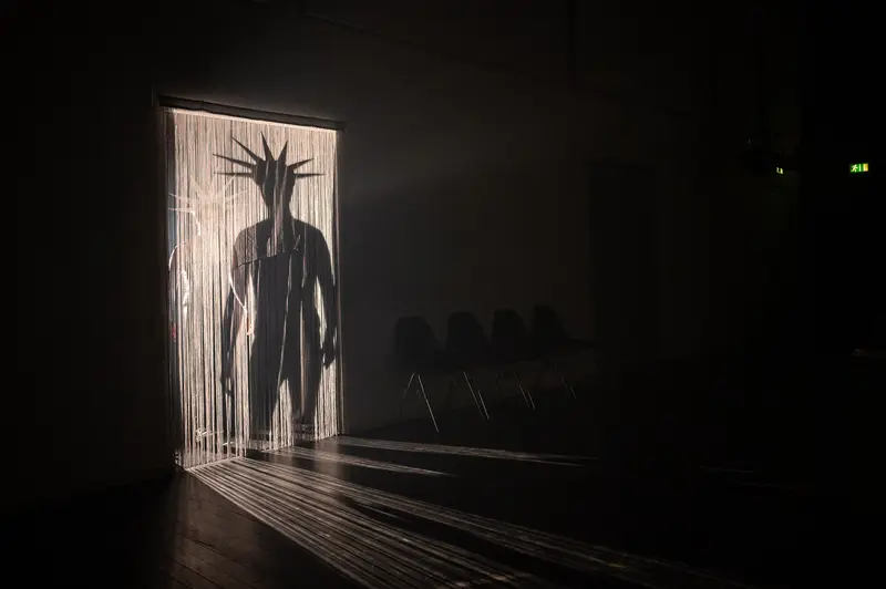 Silhouetted Figure in Dramatic Shadow Play at Kosmos Theater, Wien