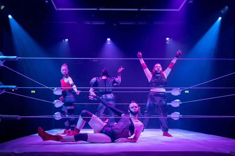 Wrestlers in Dramatic Pose During "Keeping up with the Penthesileas" Performance