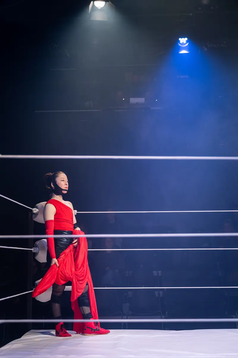 Performer in Red Costume on Dramatic Wrestling Ring Stage