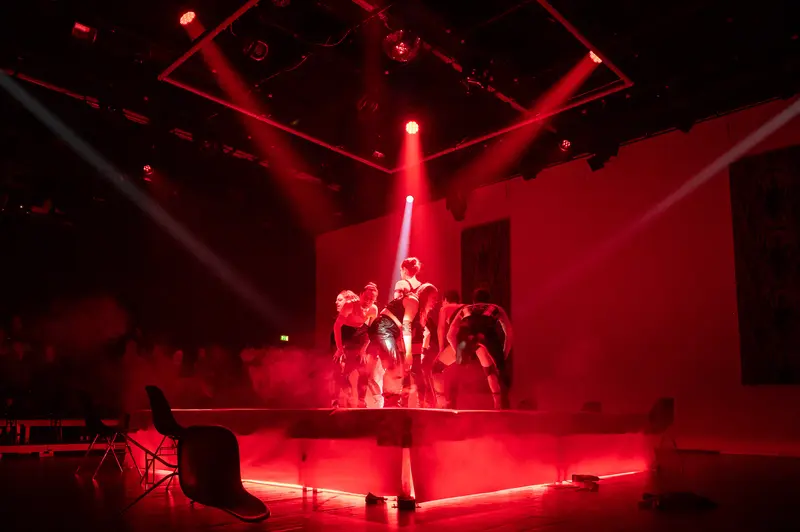 Red-Lit Dancers Performing in "Keeping up with the Penthesileas" at Kosmos Theater