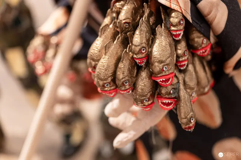 Ceramic Sardine Figurines with Red Mouths at Culinary Exhibition