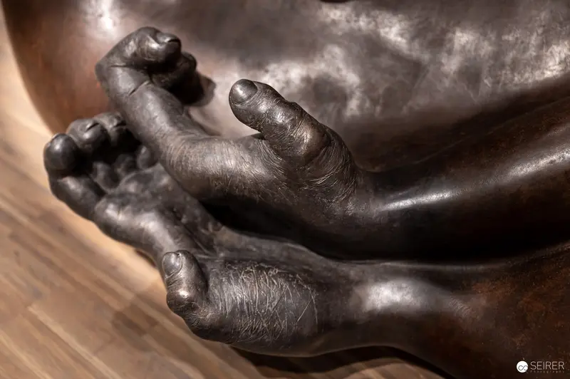 Weathered Bronze Sculpture Hands in Detailed Close-Up View