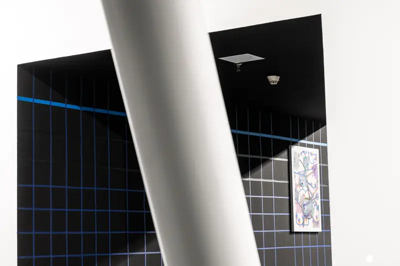 Geometric Abstraction with Blue Grid and Hanging Artwork in Gallery Space