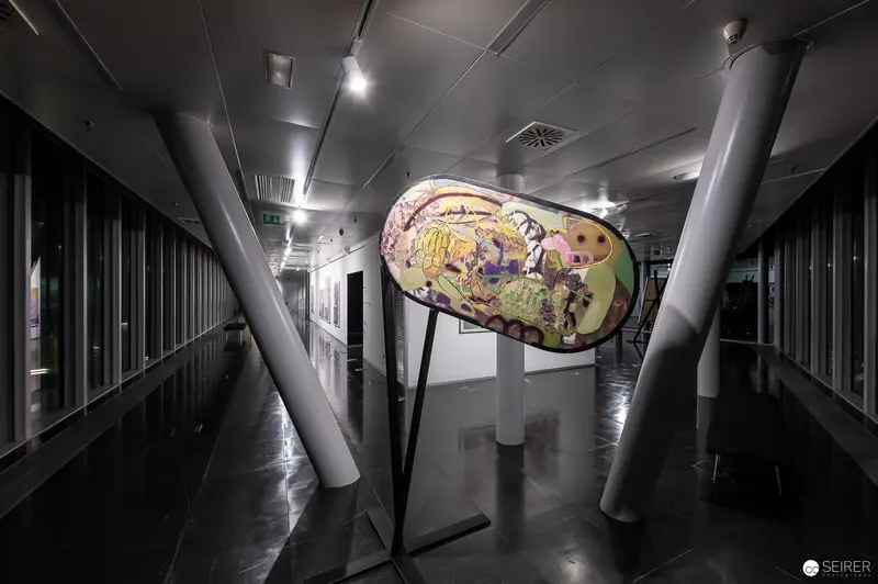 Large Illuminated Art Piece Displayed in Sleek Architectural Hallway at Strabag Kunstforum