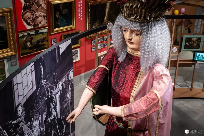 Prater Museum Mannequin in Historic Exhibition Display Alongside Vintage Photographs