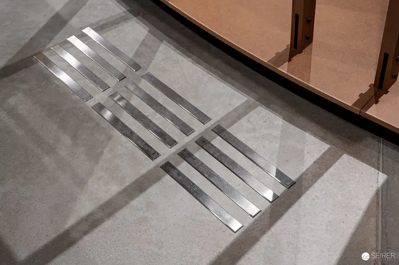 Architectural Detail: Minimalist Metal Grate on Concrete Floor with Shadow
