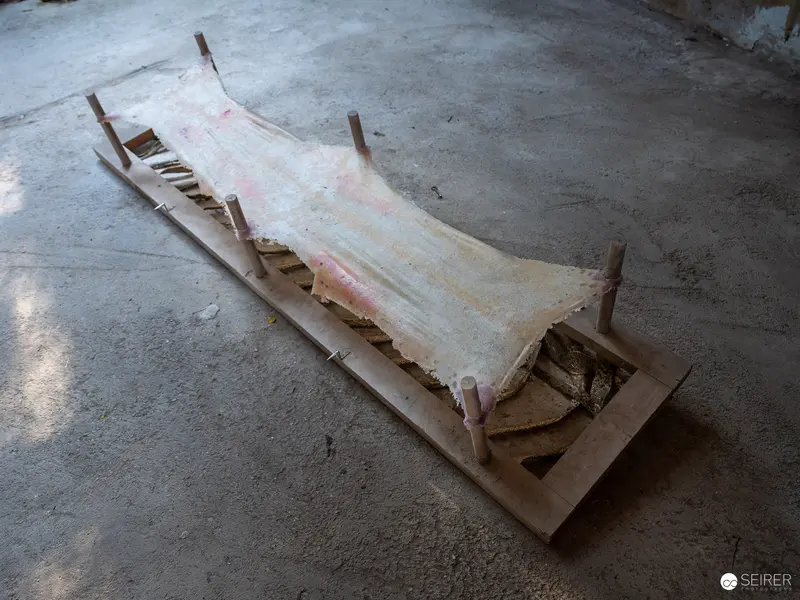 Weathered Wooden Frame with Stretched Translucent Material at Nocturnal Cave Exhibition