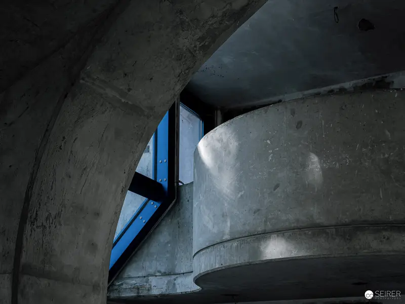 Concrete Architecture with Blue Window Fragment in Nocturnal Cave Exhibition Space