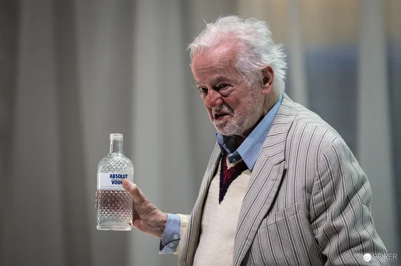Seasoned Actor Martin Schwab Holds Absolut Vodka Bottle During Theater Rehearsal