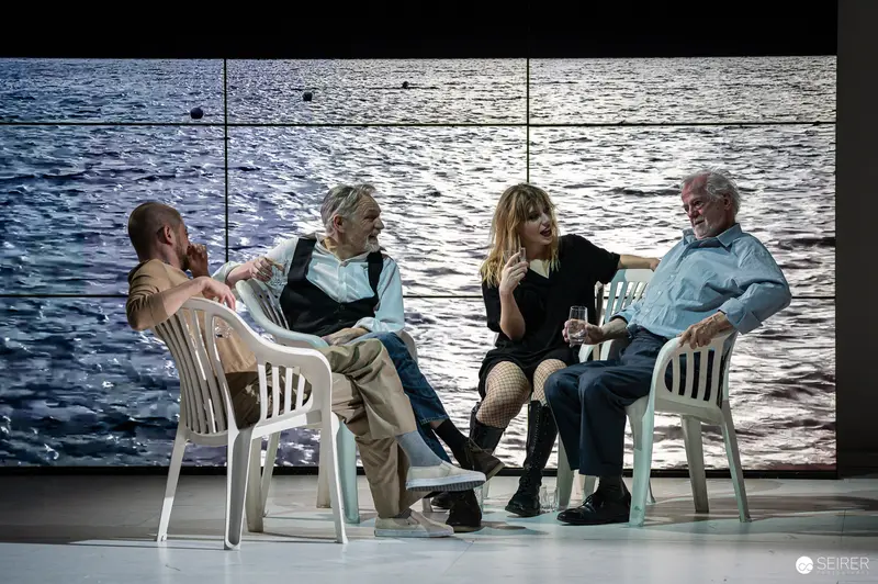 Behind the Scenes of "The Seagull" - Actors in Staged Seaside Conversation