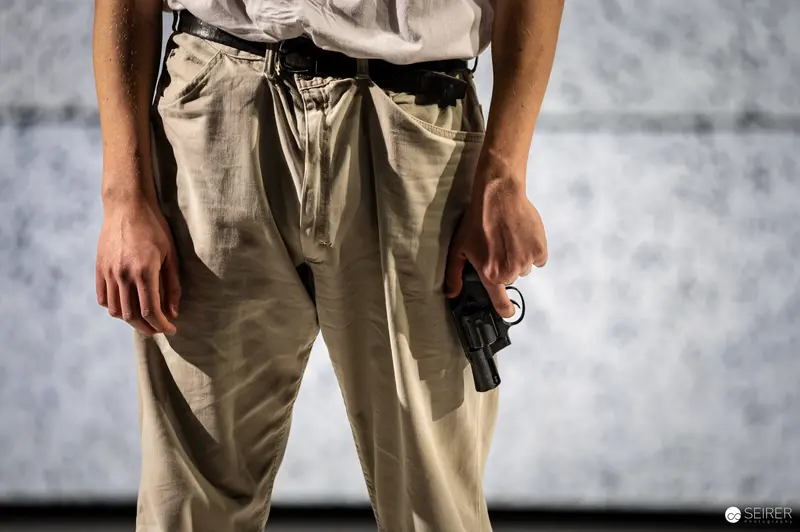 Actor Holding Handgun During Rehearsal for Chekhov's "The Seagull" Theater Production