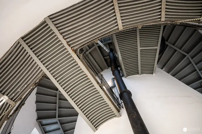 Curved Metal Staircase Interior with Corrugated Architectural Elements
