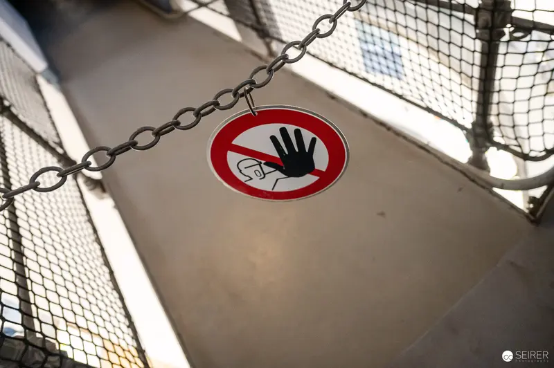 No Entry Warning Sign on Chained Metal Mesh Barrier