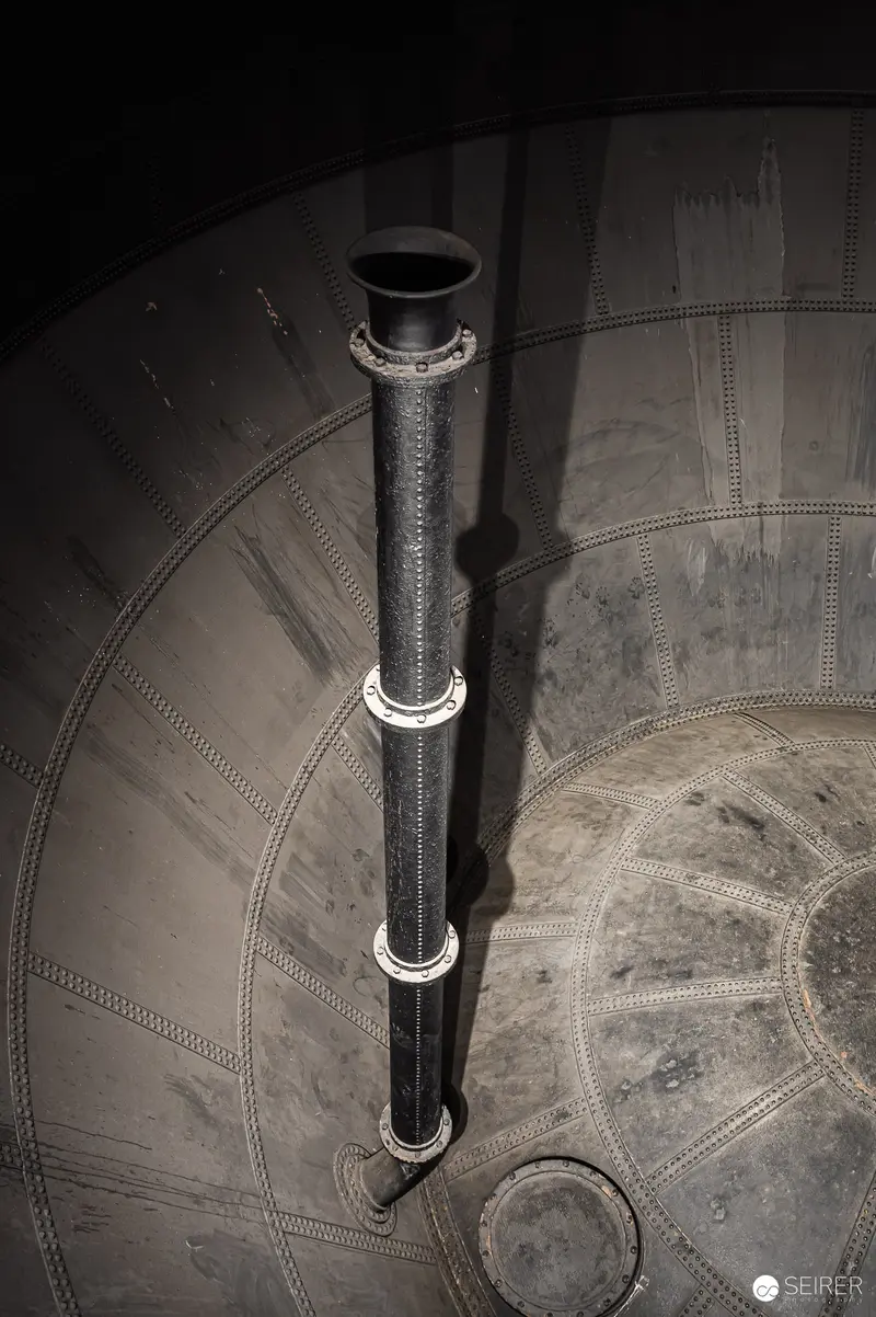 Industrial Water Tower Interior Metallic Vertical Pipe and Curved Wall