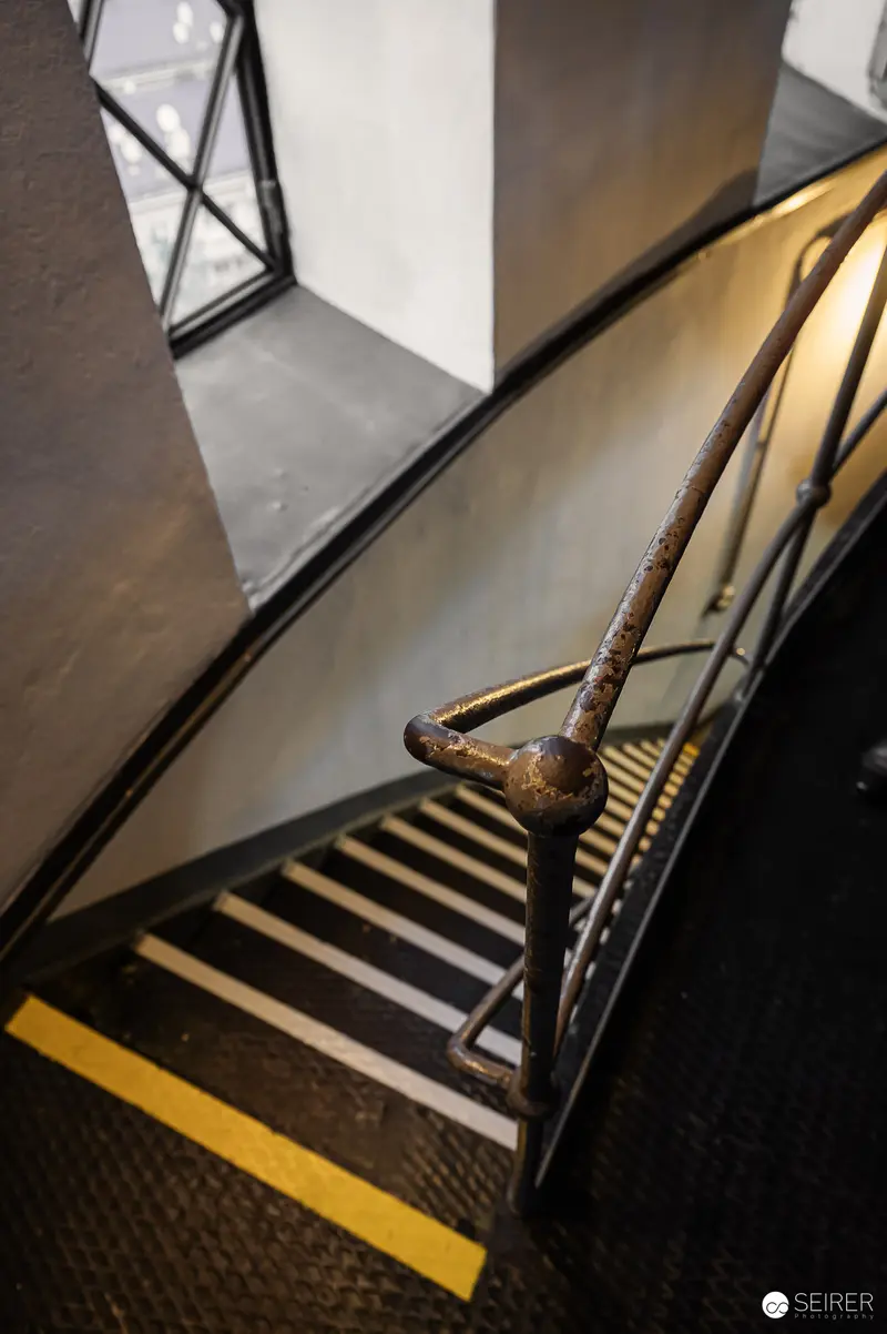 Steep Industrial Staircase with Yellow Safety Markings in Urban Setting