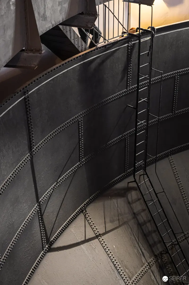 Industrial Water Tower Interior with Curved Metal Tank and Ladder