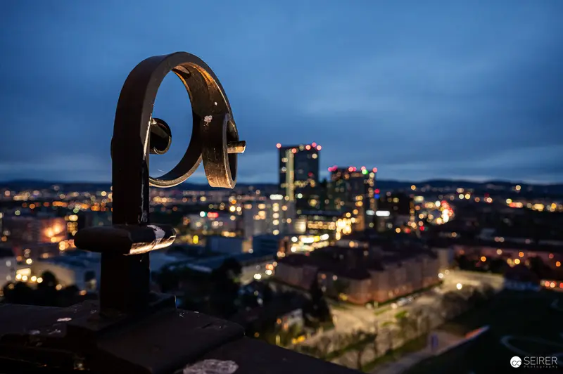 Nighttime City Skyline Viewed Through Ornate Vintage Telescope