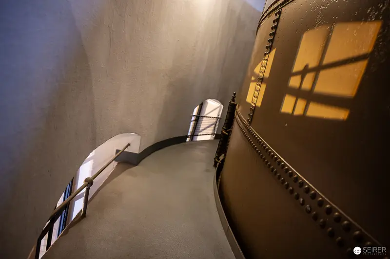 Curved Water Tower Interior with Dramatic Sunlight and Window Shadows