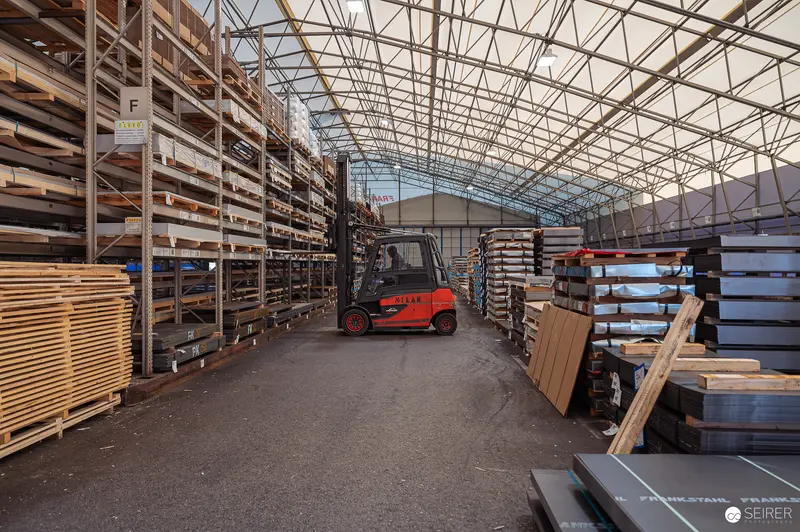 Frankstahl Industrial Photography: Warehouse Interior with Forklift and Stacked Wood Materials