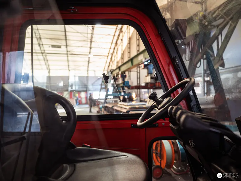 Red Forklift Interior at Industrial Warehouse Facility