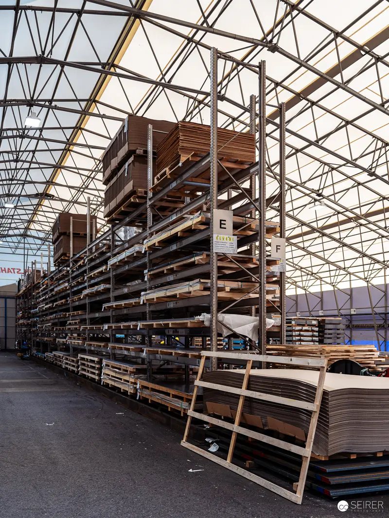 Stacked Wooden Panels in Industrial Warehouse Storage Facility
