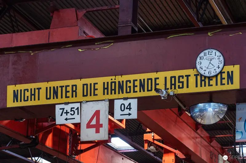 German Industrial Facility Warning Sign Under Suspended Load Marker