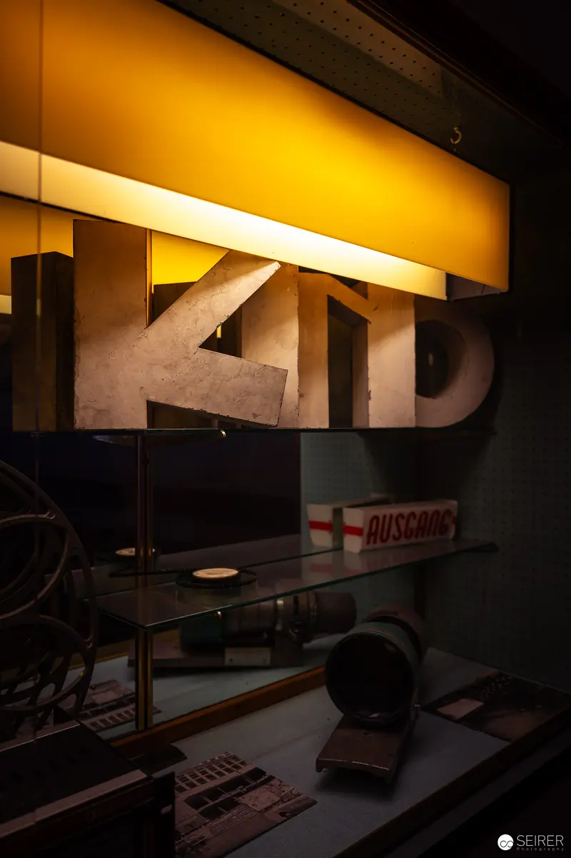 Illuminated Typography and Design Objects in Shadowy Interior