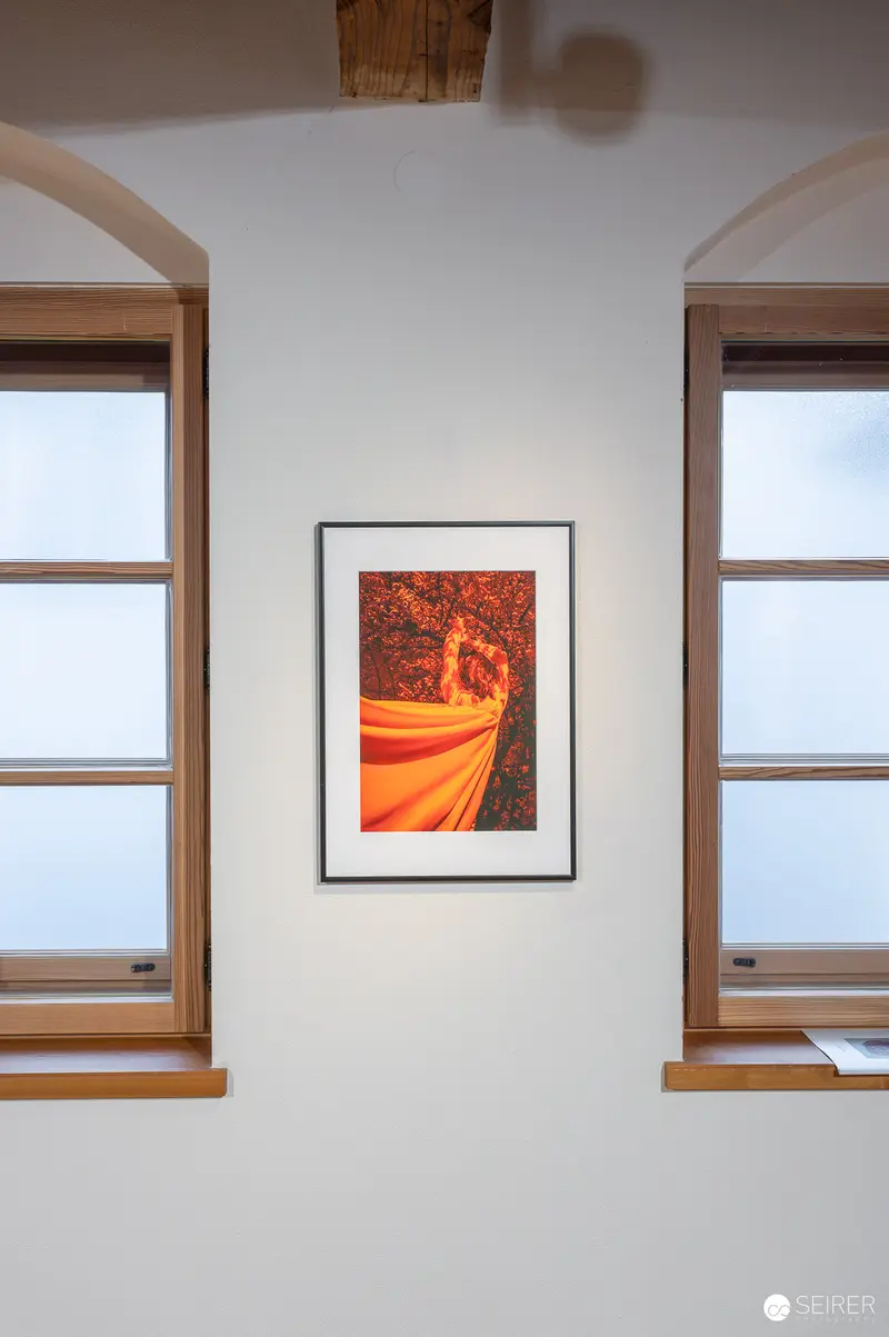Framed Orange Artwork Between Windows at Hide & Seek Exhibition, Traismauer