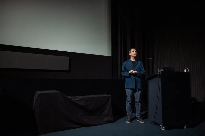 Presenter on Stage at 60 Years of Filmmuseum Event