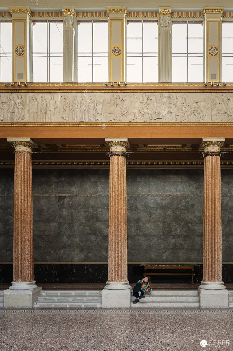 Solitary Figure Amid Classical Architecture at Akademie der Bildenden Künste Exhibition