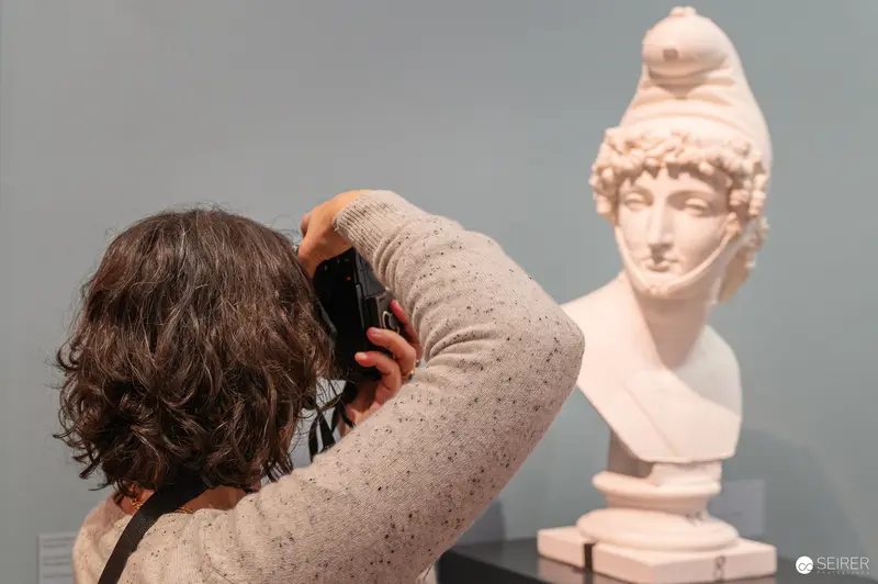 Museum Visitor Photographs Classical Marble Bust at Academy of Fine Arts Exhibition