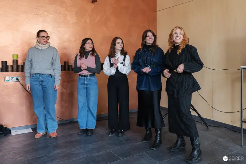 Five Participants at Construction Site Preview with Copper-Colored Interior Wall