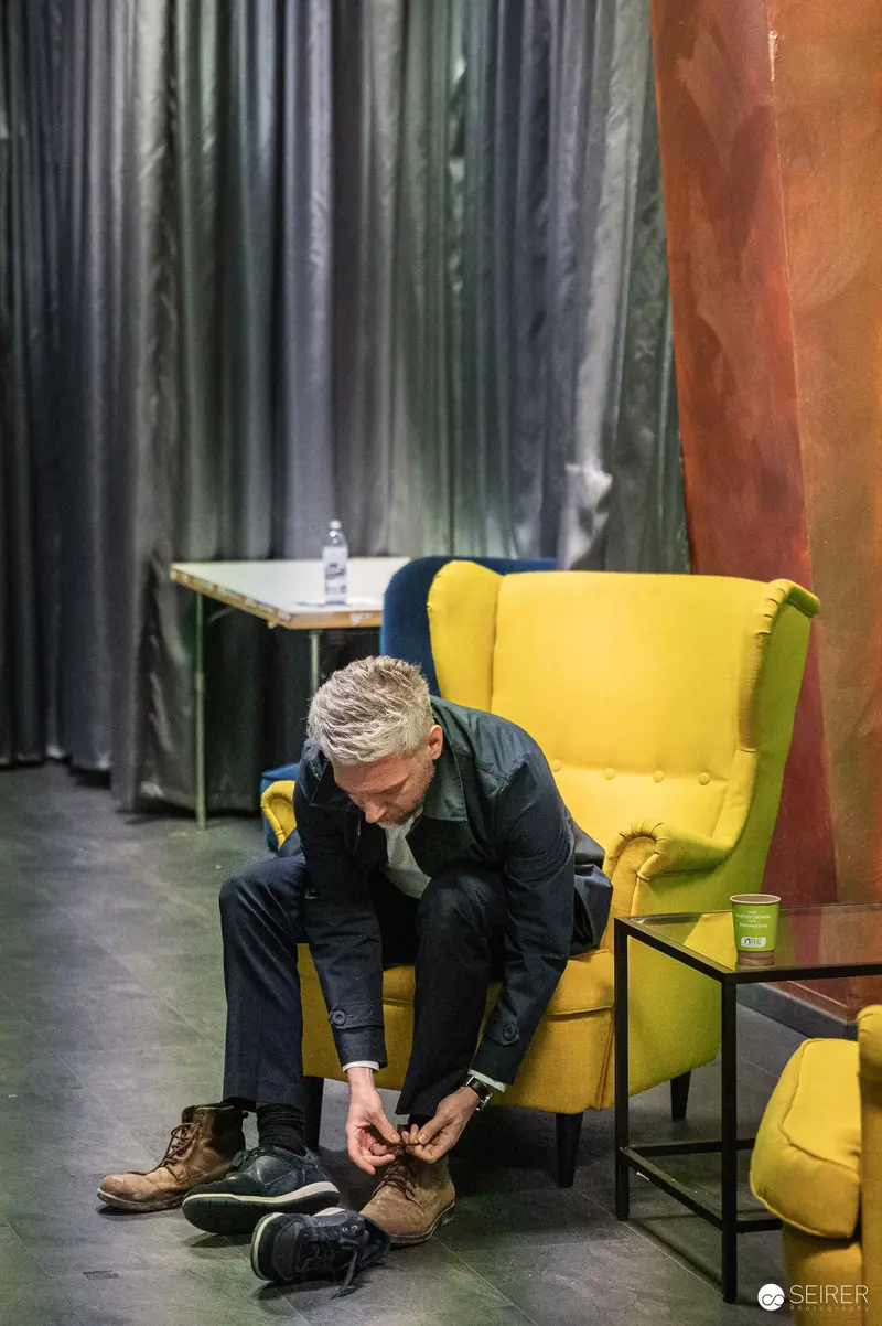 Visitor Tying Shoes During Construction Site Press Preview