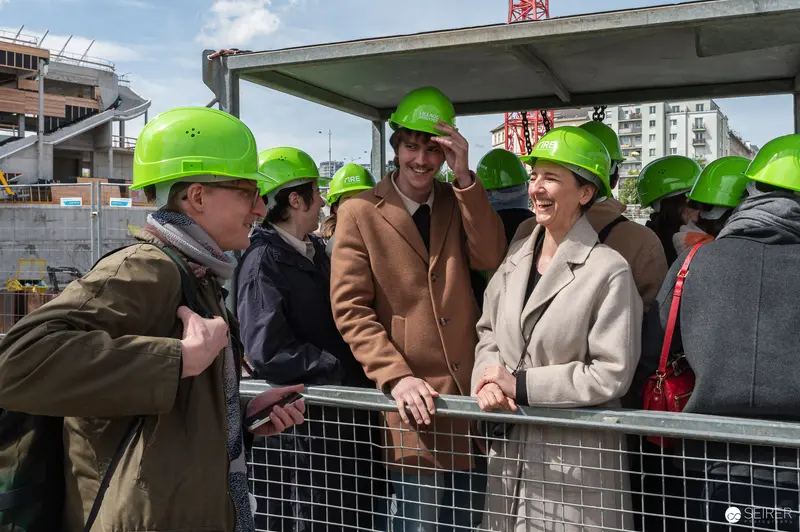 Construction Site Tour with Business Officials in Safety Helmets