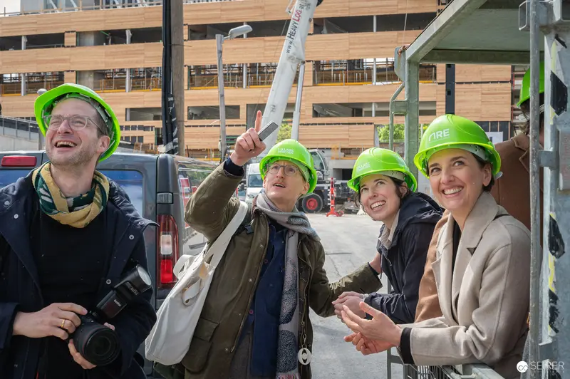 Construction Site Press Preview with Safety Helmets and Crane Tour