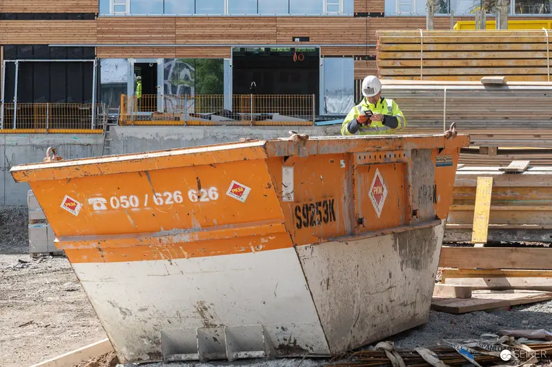 Construction Worker on Break at Active Building Site