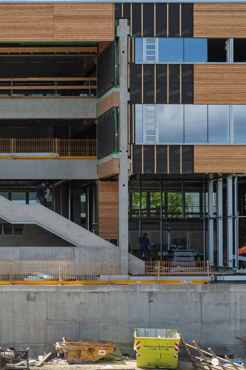 Multi-Story Building Under Construction with Wood and Glass Facade