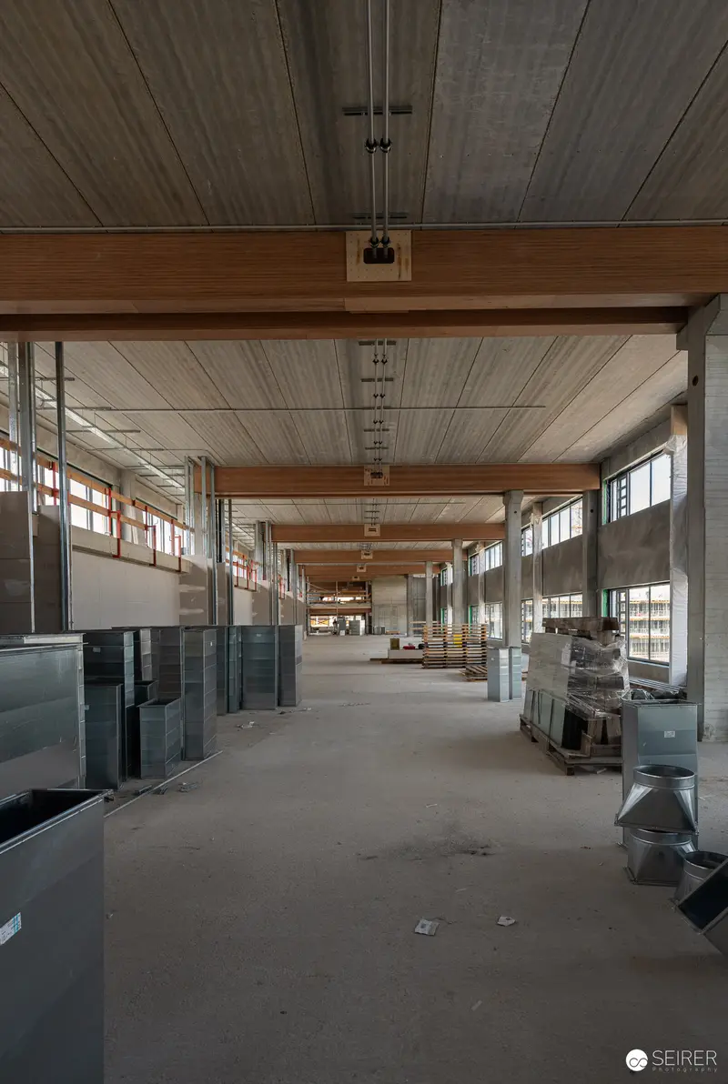 Industrial Construction Site Interior with Exposed Wooden Beams and Concrete Flooring