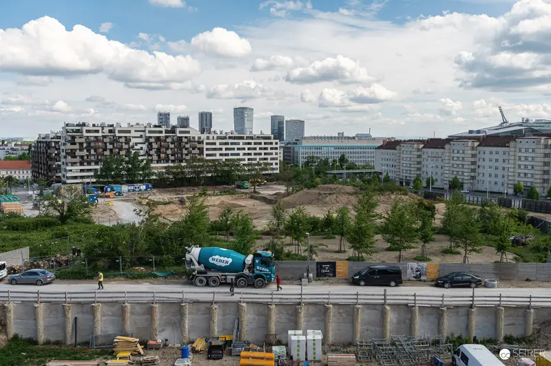 Urban Construction Site with Concrete Mixer and Residential Buildings