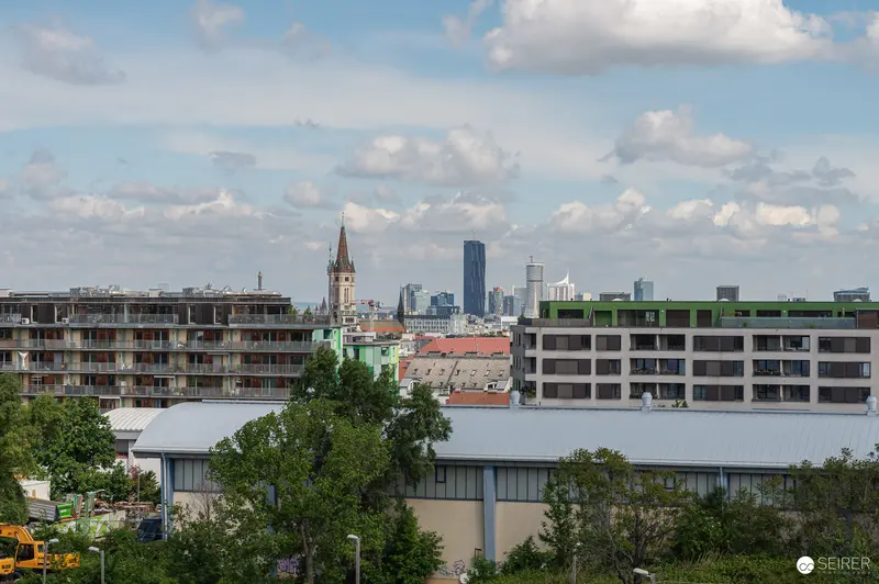 Urban Construction Site with Church Spire and Modern Skyline