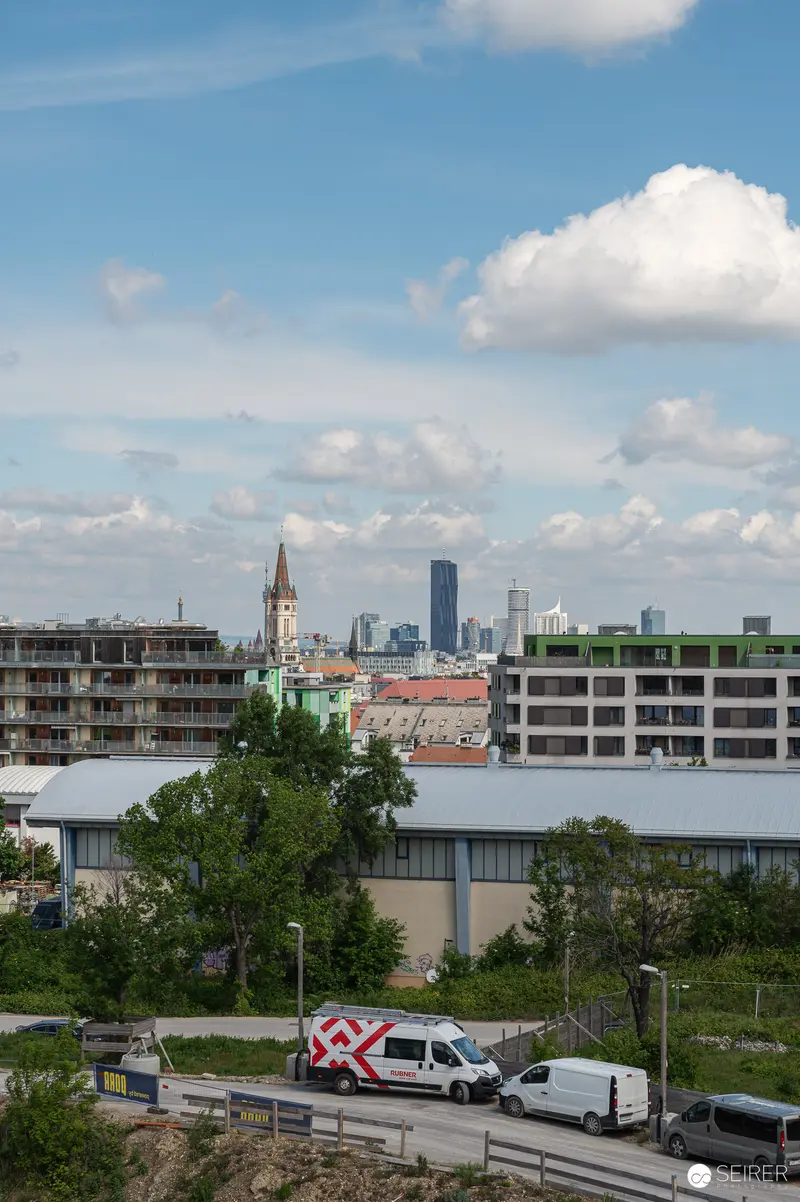 Urban Development Site with Historic Church Spire and Emergency Vehicle